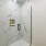 shower area with marble tiles